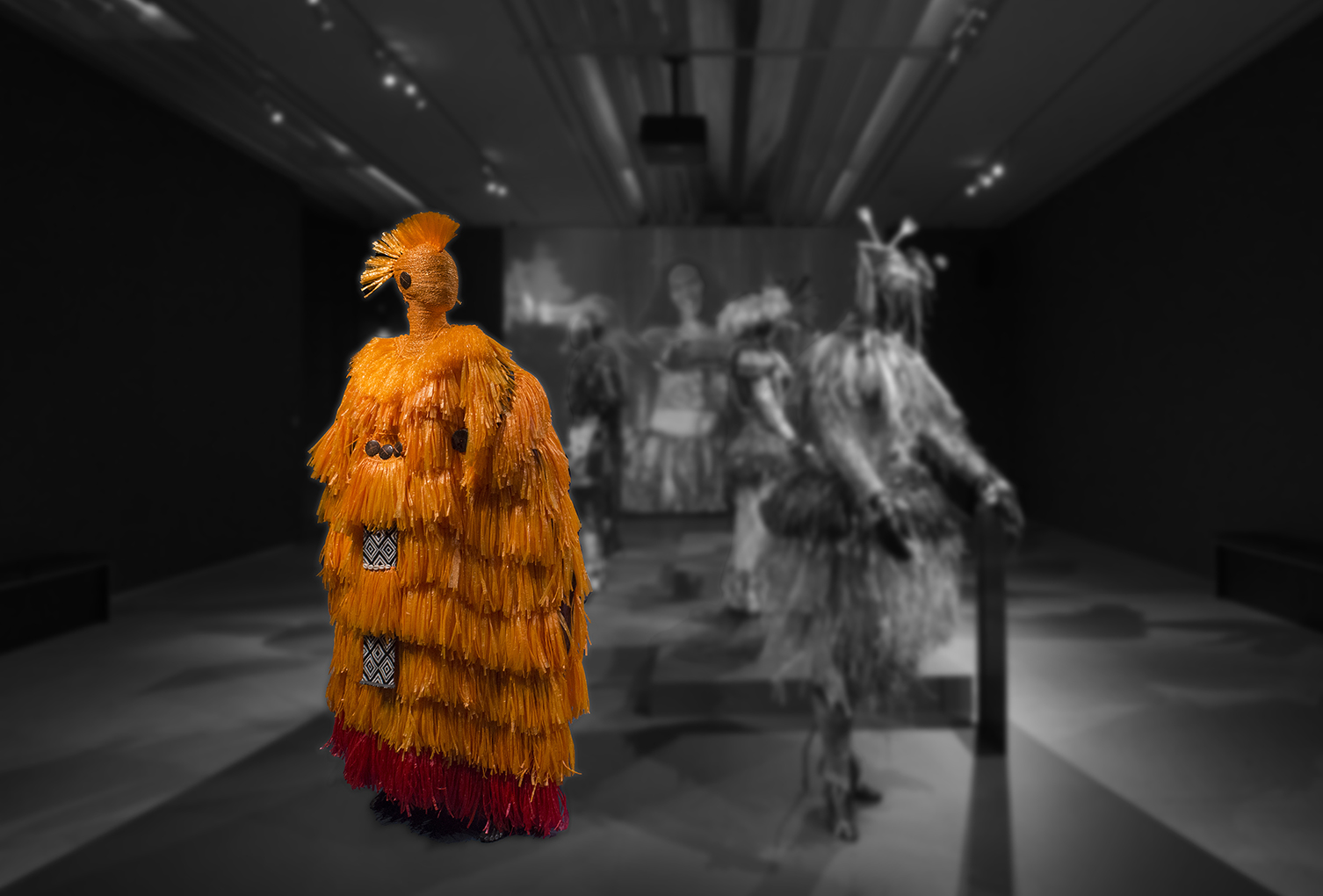 An exhibition display featuring a group of mannequins dressed in outfits by the Pacific Sisters.