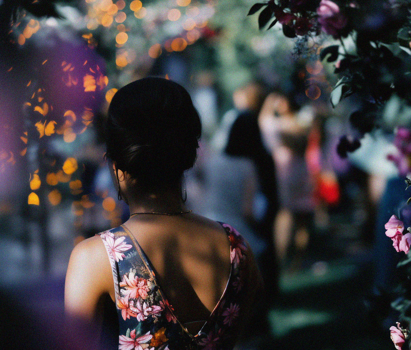 Person walking through a floral archway