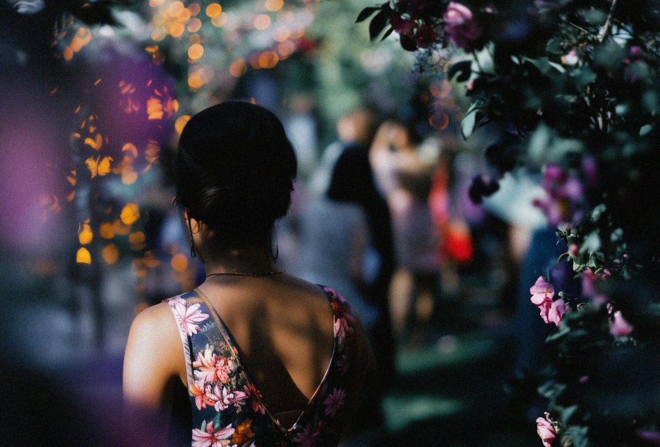 woman walking through a floral archway